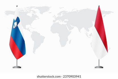 Slovenia and Monaco flags for official meeting against background of world map.