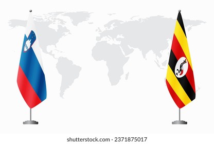 Slovenia and Uganda flags for official meeting against background of world map.