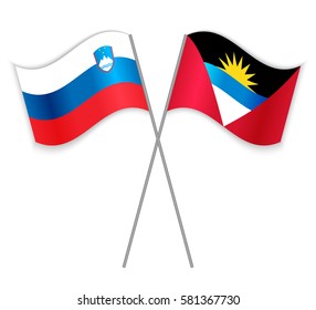 Slovenian and Antiguan crossed flags. Slovenia combined with Antigua and Barbuda isolated on white. Language learning, international business or travel concept.
