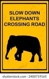 Slow Down Elephants Crossing Road sign