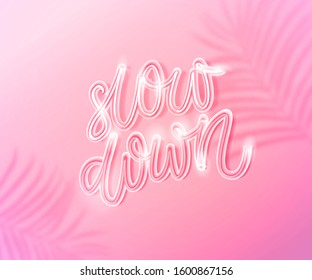 Slow down. Inspirational quote about slowing life, making breaks and minfulness lifestyle. White neon glowing text on pastel pink background with tropic leaves shadow overlay