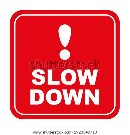 slow down sign on red background	