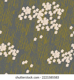 Small beige flowers on the green grass background. Seamless pattern.