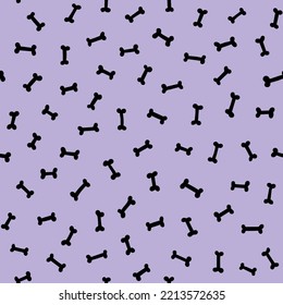 Small black bones scattered on light purple background cute Halloween seamless pattern. Doggy bone pastel violet repeat background. Lavender pet lover design.