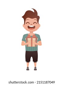 A small boy child is depicted in full growth and holds a gift in his hands. Birthday, New Year or holidays theme. Isolated. Cartoon style.