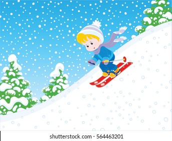 Small boy skiing down the snowy hill