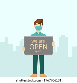Small business owner wearing face mask holding sign now we are open again. support local business reopening shop concept. coronavirus covid-19 prevention in new normal