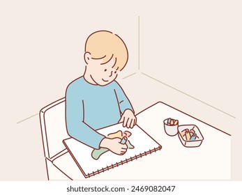 small child draws with pastel crayons on white table. Hand drawn style vector design illustrations.