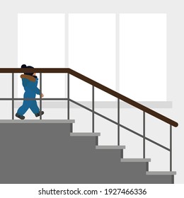 A small child in warm clothes descends the stairs against the background of a wall with a window