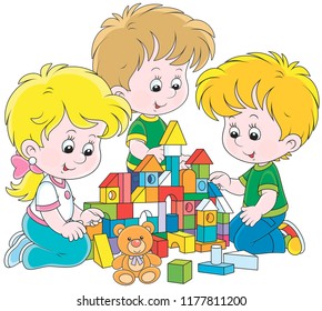 Small children playing with multicolor bricks and building a toy castle