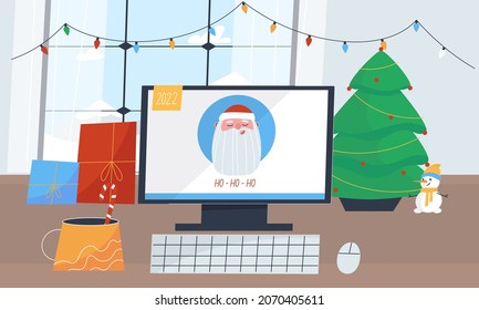 Small Christmas tree stands on the table by the window with the computer. New Year's mood at the workplace with a cup and presents. Holiday at the freelancer's remote workplace 