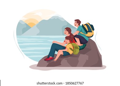 
Small family watching the sunset on the rock 