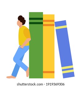 A small figurine of a guy is leaning on huge books