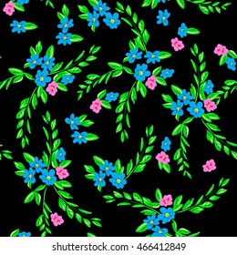 Small flowers background. Cute meadow blossom flowers with green leaves on a black.