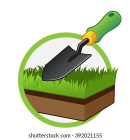 Small gardening shovel and a piece of grass