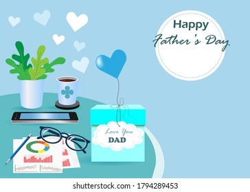 Small gift with greeting card "Love you Dad" on Father's working desk with smart phone, eyeglasses, coffee and working graph sheets. Father's day concept.