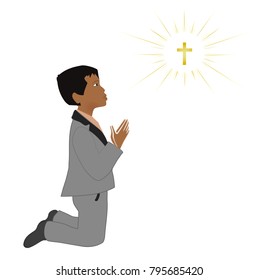 Small latin boy praying on knees. First communion sacrament.