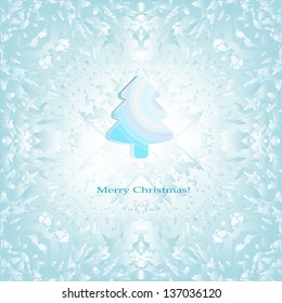A small paper Christmas tree on a blue abstract background. Christmas card with space for your text.