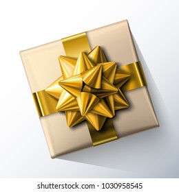 Small paper gift box with big glittering golden bow and ribbons isolated on white background. Top view. Vector realistic festive illustration. Decoration element for holiday design.