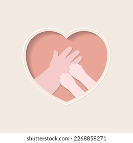 Small paws of cat on hand of kid, in pink heart shaped frame paper art 
