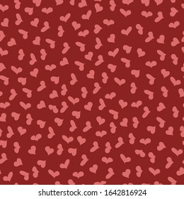 small pink hearts of different shapes on a red background.