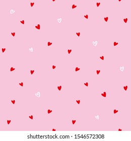 Small red hearts on a pink background seamless pattern for Valentine’s day decoration, fabric printing, wrapping paper design.