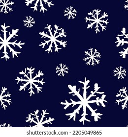 Small white ink snowflakes isolated on dark blue background. Cute monochrome Christmas seamless pattern. Vector simple flat graphic hand drawn illustration. Texture.