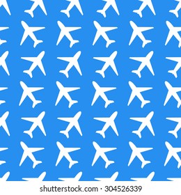 Small white plane icons on blue background seamless pattern
