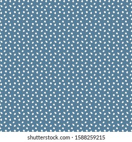 Small white shapes with irregular and sharp edges, sprinkled on a dark blue surface. Textile pattern. Wrapping paper. Spotted background.