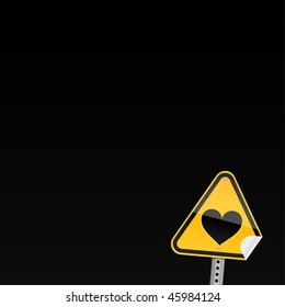 Small yellow road hazard warning sign with heart symbol and with curved corner on black background