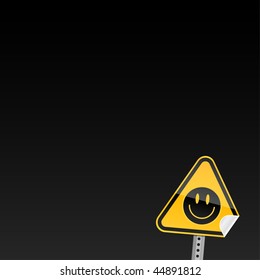 Small yellow road warning sign with black smiley symbol with curved corner on a dark background