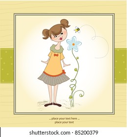 small young lady who smells a flower