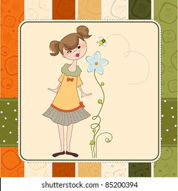 small young lady who smells a flower