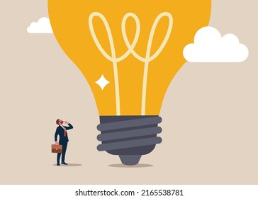 smart entrepreneur thinking with big oversized idea light bulb. Think big, aspiration to win and success in business, big idea from creativity and imagination to overcome fear.