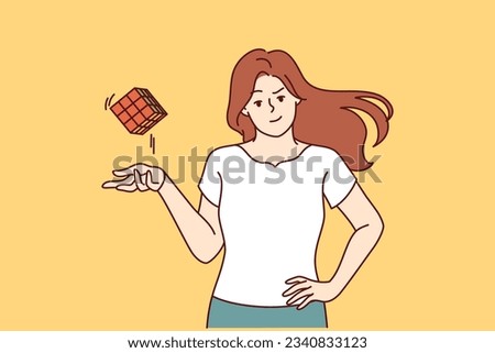 Smart girl throws assembled cube puzzle with ease, having coped with difficult task to find out IQ. Young girl is proud of high intelligence and looks at screen demonstrating popular puzzle