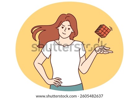 Smart girl throws assembled cube puzzle with ease, having coped with difficult task to find out IQ. Young girl is proud of high intelligence and looks at screen demonstrating popular puzzle