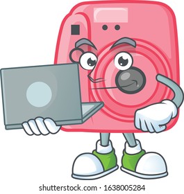 A smart instan camera mascot icon working with laptop