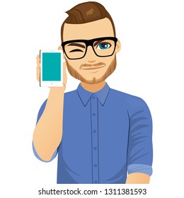 Smart man with glasses showing phone gadget winking