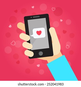 Smart phone in hand with message (love). On the pink background with hearts and dots.