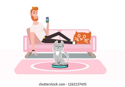 Smart vacuum cleaner. A man controls a vacuum cleaner using a smartphone, lying on a comfortable sofa. Cat plays with a vacuum cleaner, rides a smart vacuum cleaner, hunts moving household appliances