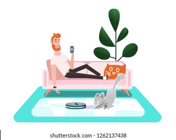 Smart vacuum cleaner. A man controls a vacuum cleaner using a smartphone, lying on a comfortable sofa. Cat plays with a vacuum cleaner, rides a smart vacuum cleaner, hunts moving household appliances