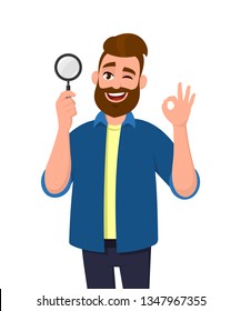 Smart young man holding magnifying glass and gesturing okay/OK sign while winking eye. Deal, good, agree, search, find, discovery, analyze, inspect, investigation concept illustration in cartoon.