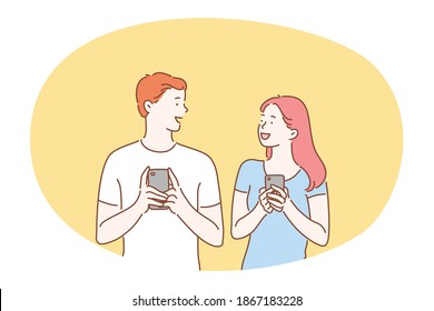 Smartphone, camera, technologies concept. Young smiling couple teens standing with smartphones in hands and looking at each other vector illustration. Online, chatting, dating, selfie 