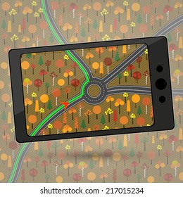 Smartphone with GPS navigation. Device with Global Positioning System module. Navigation in countryside autumn forest. Navigation within a roundabout in a country where traffic drives on the left. 