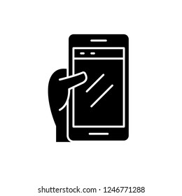 Smartphone in hand black icon, vector sign on isolated background. Smartphone in hand concept symbol, illustration 