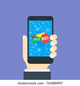 Smartphone in the hand in a flat style. On the phone screen is a banner for sale.