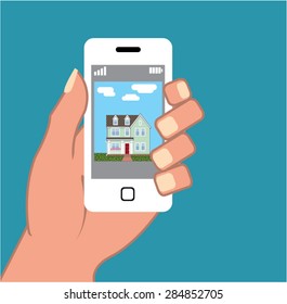 Smartphone in hand with house picture Vector