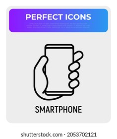 Smartphone in hand thin line icon. Modern vector illustration.