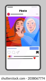 Smartphone with interface of photo social network, media account in internet, display, screen. Selfie of two happy girls in funny costumes. Likes, comments, popularity. Photo mobile application