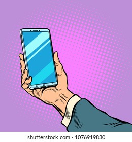 Smartphone in male hand selfie. Pop art retro vector illustration comic cartoon kitsch drawing